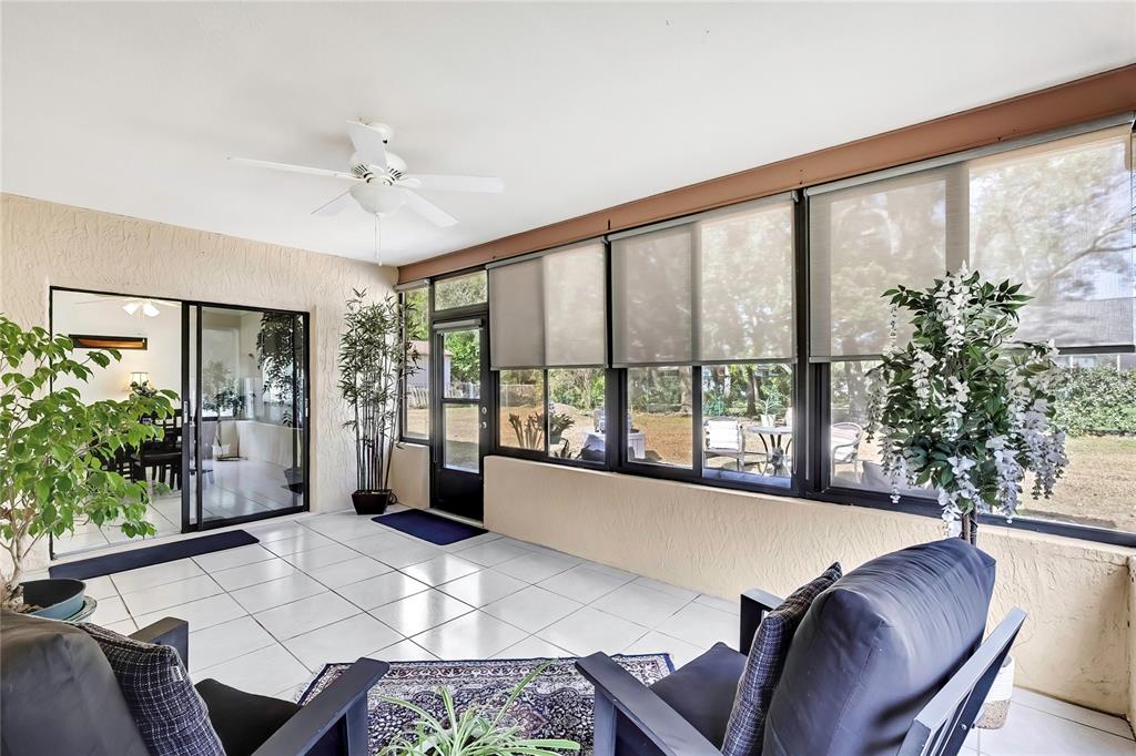 9059 Gaynor Street Spring Hill, FL 34608 - Photo 6 of 36 a living room with furniture and potted plants