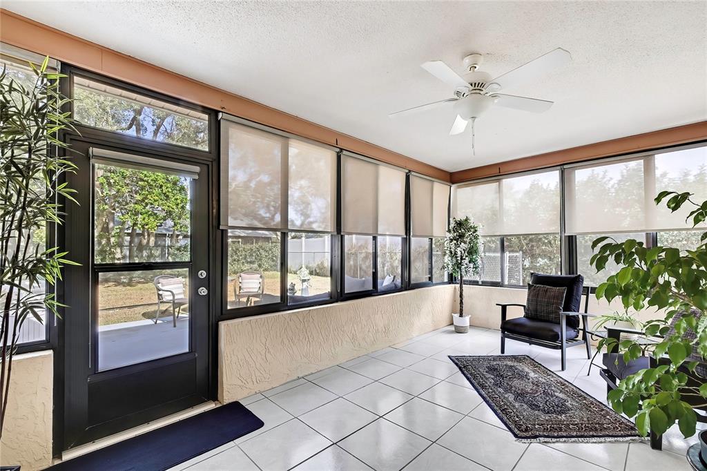 9059 Gaynor Street Spring Hill, FL 34608 - Photo 7 of 36 a living room with furniture and a large window