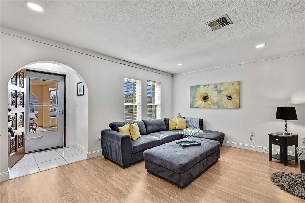 9059 Gaynor Street Spring Hill, FL 34608 - Photo 9 of 36 a living room with furniture and wooden floor