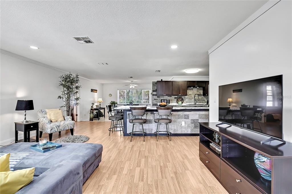 9059 Gaynor Street Spring Hill, FL 34608 - Photo 10 of 36 a living room with lots of furniture and kitchen view