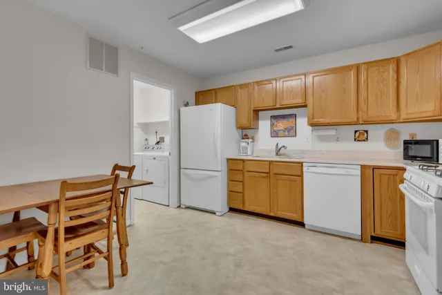 a kitchen with a stove a refrigerator and a stove top oven