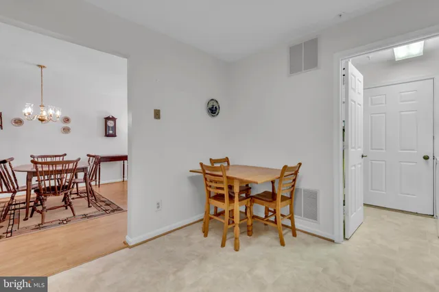 a view of a dining room with furniture and chandelier