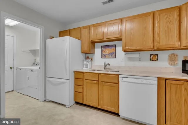 a kitchen with stainless steel appliances granite countertop a refrigerator and cabinets
