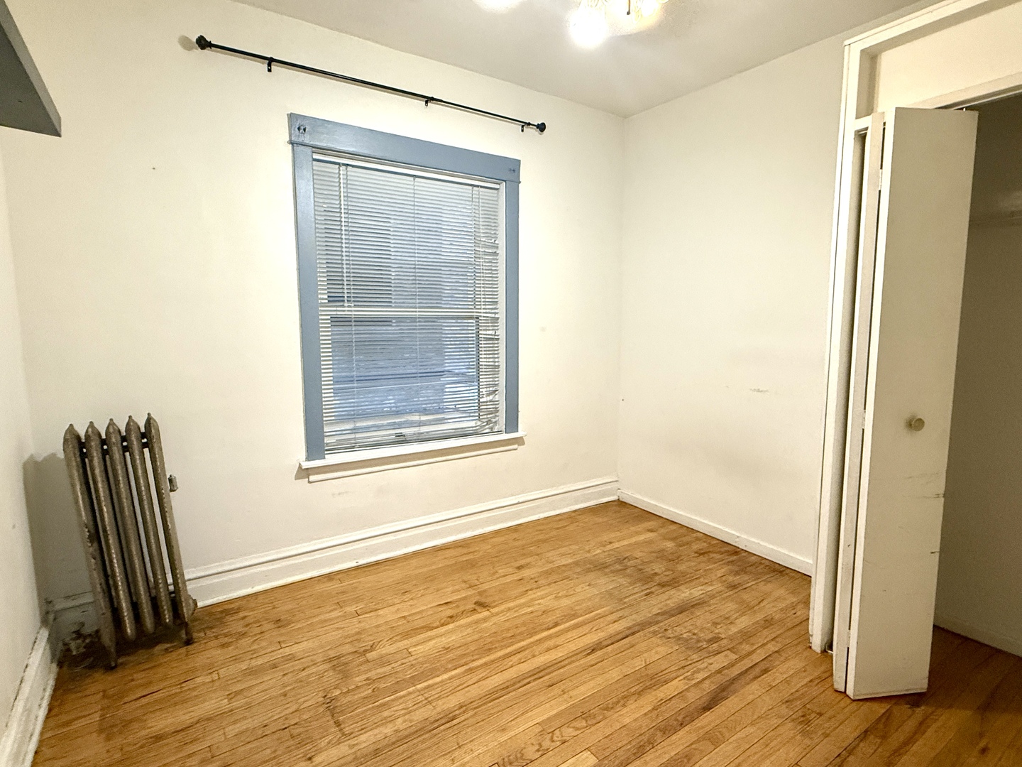 4134 North Keystone Avenue, Unit 1SW Chicago, IL 60641 - Photo 6 of 7 a view of an empty room with wooden floor and a window