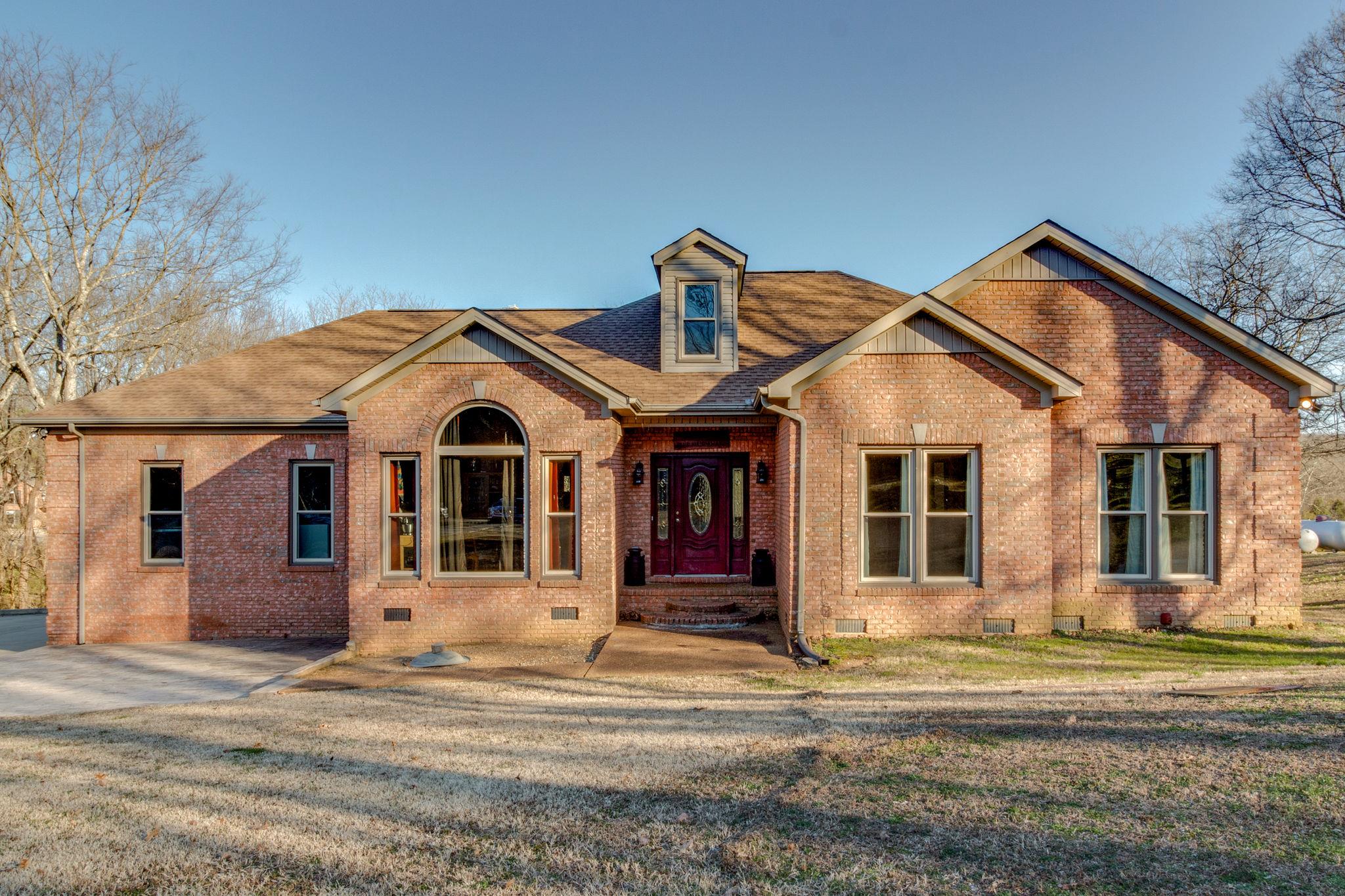 a front view of a house with a yard