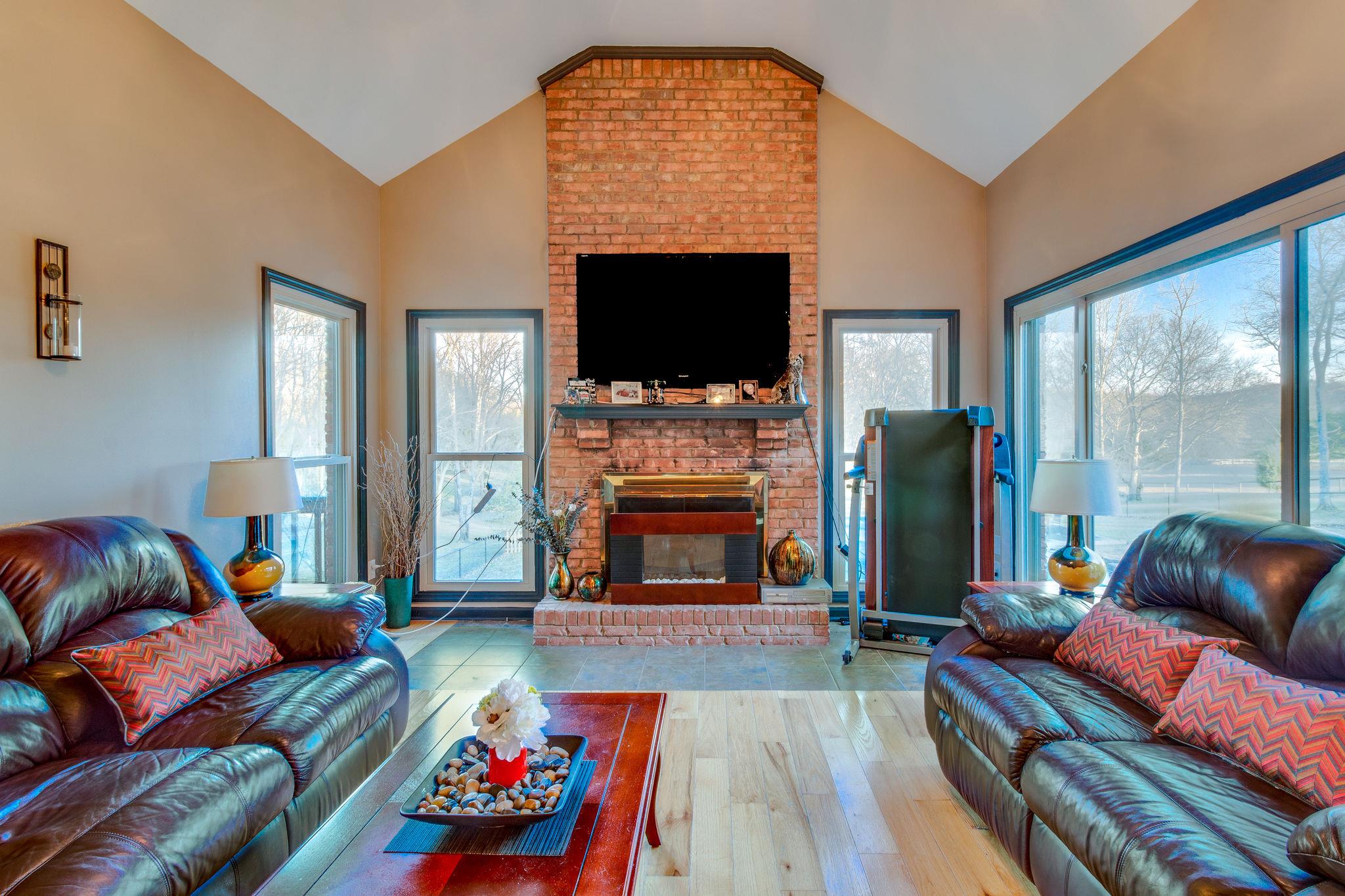 1040 Rip Steele Road Columbia, TN 38401 - Photo 12 of 25 a living room with furniture a flat screen tv and a fireplace
