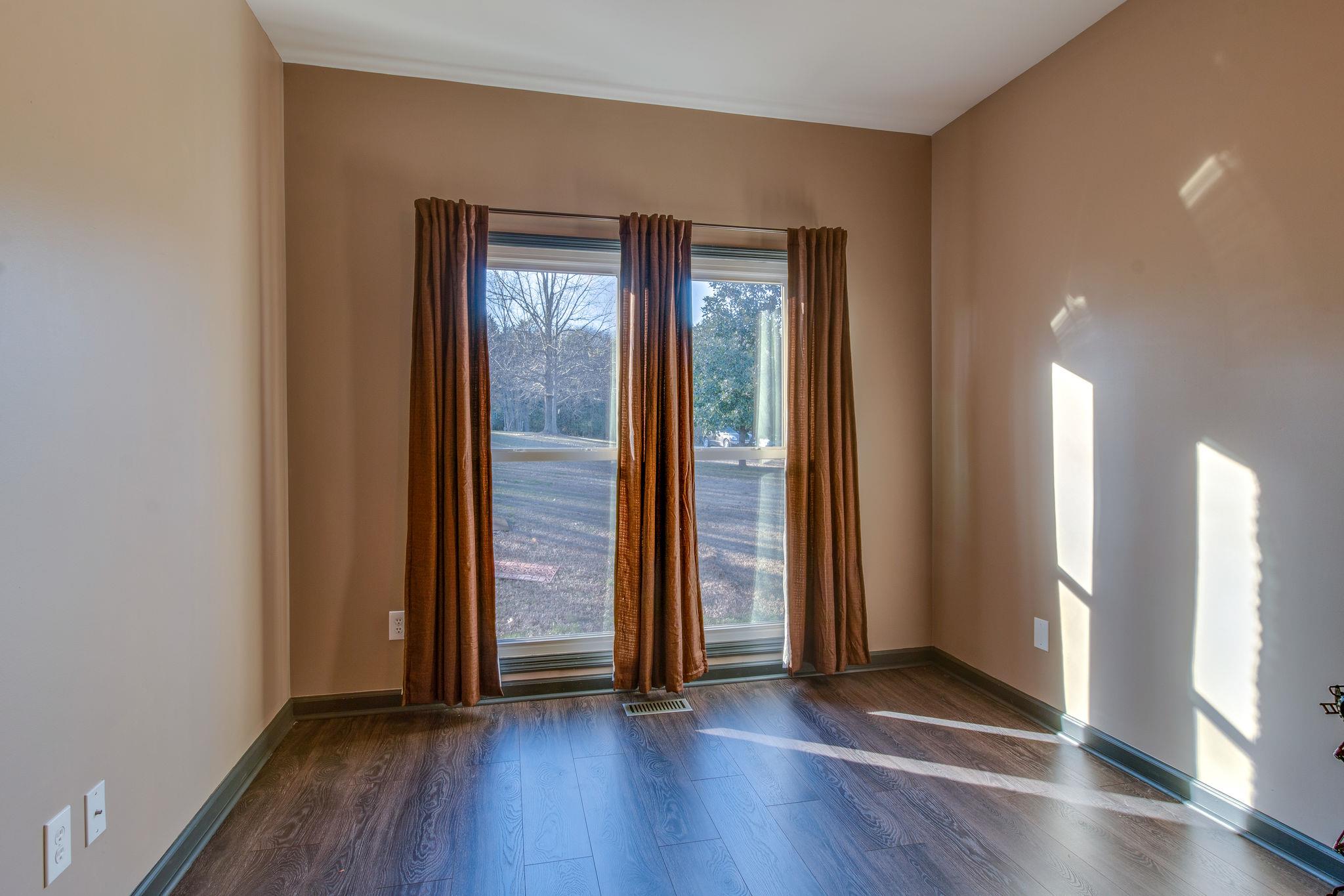 1040 Rip Steele Road Columbia, TN 38401 - Photo 17 of 25 an empty room with wooden floor and windows