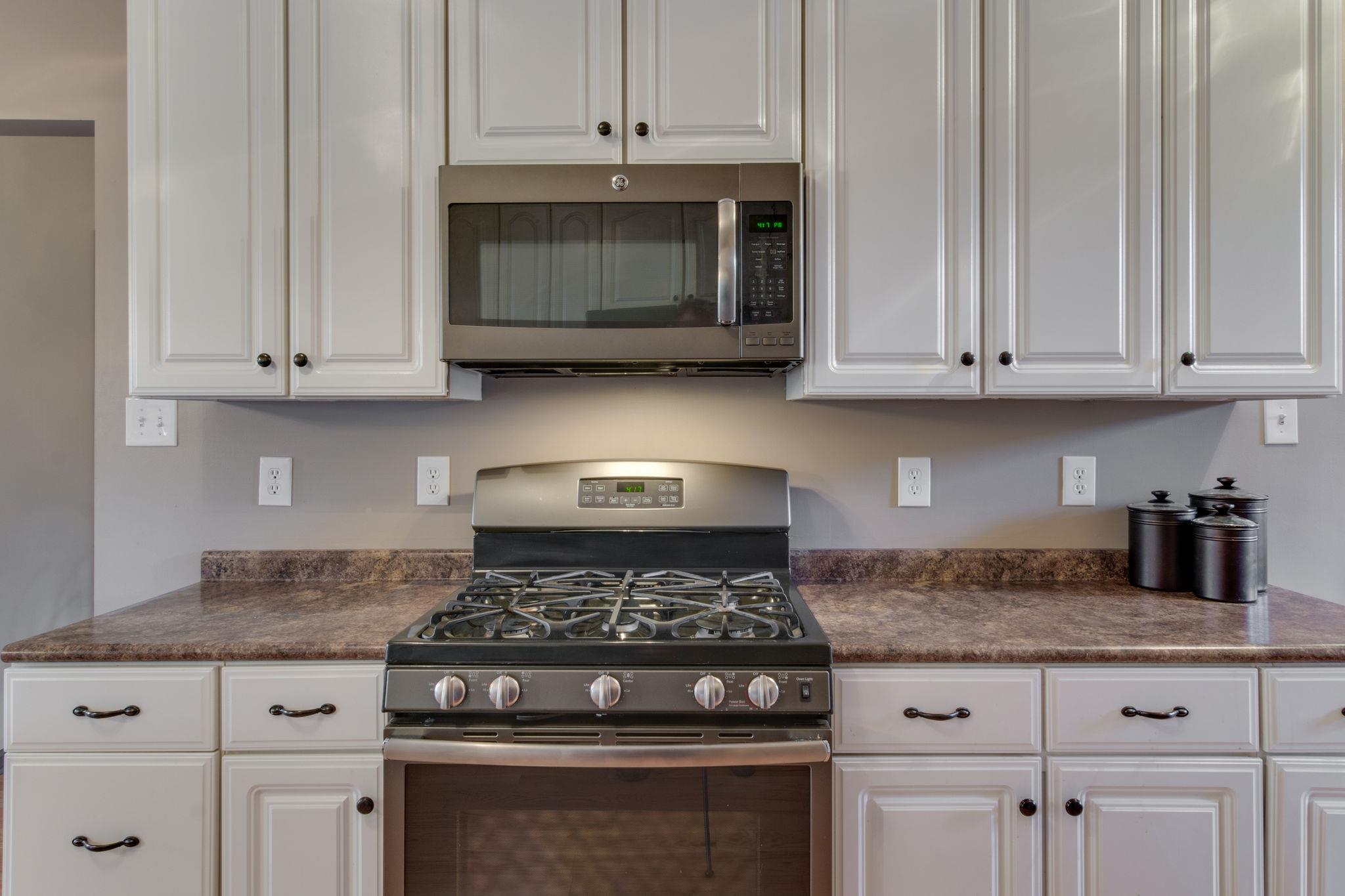 1040 Rip Steele Road Columbia, TN 38401 - Photo 8 of 25 a kitchen with granite countertop white cabinets and stainless steel appliances
