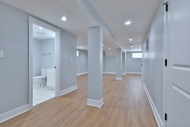 a view of a big room with wooden floor and a bathroom