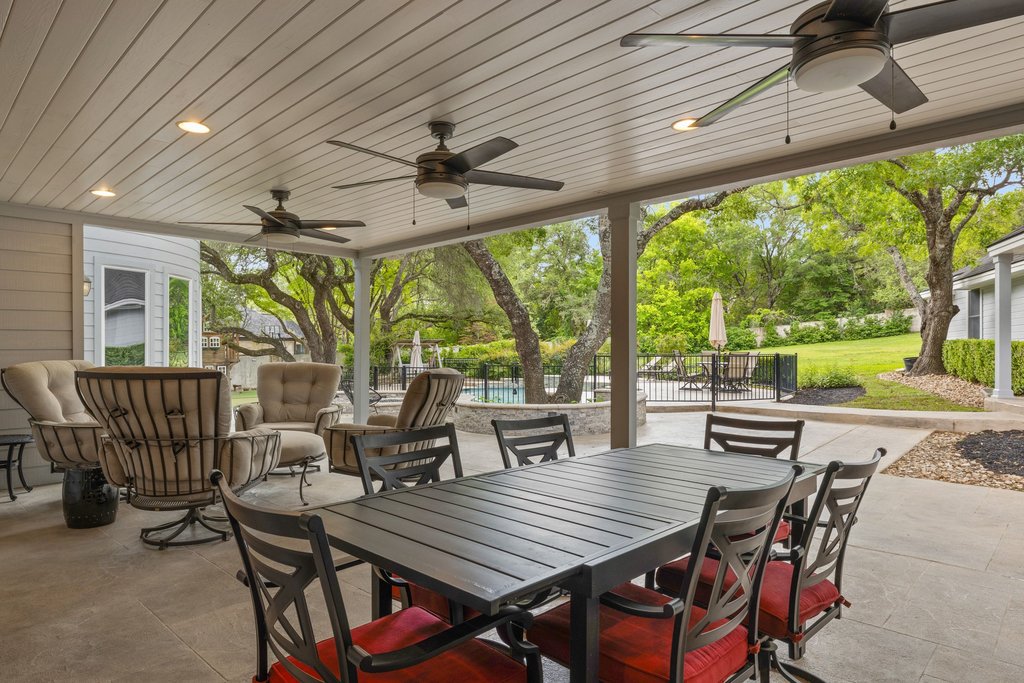 7609 Sandia Loop Austin, TX 78735 - Photo 26 of 40 An expansive covered patio provides a shaded outdoor living and dining area, complete with recessed lighting and multiple ceiling fans for year-round comfort.