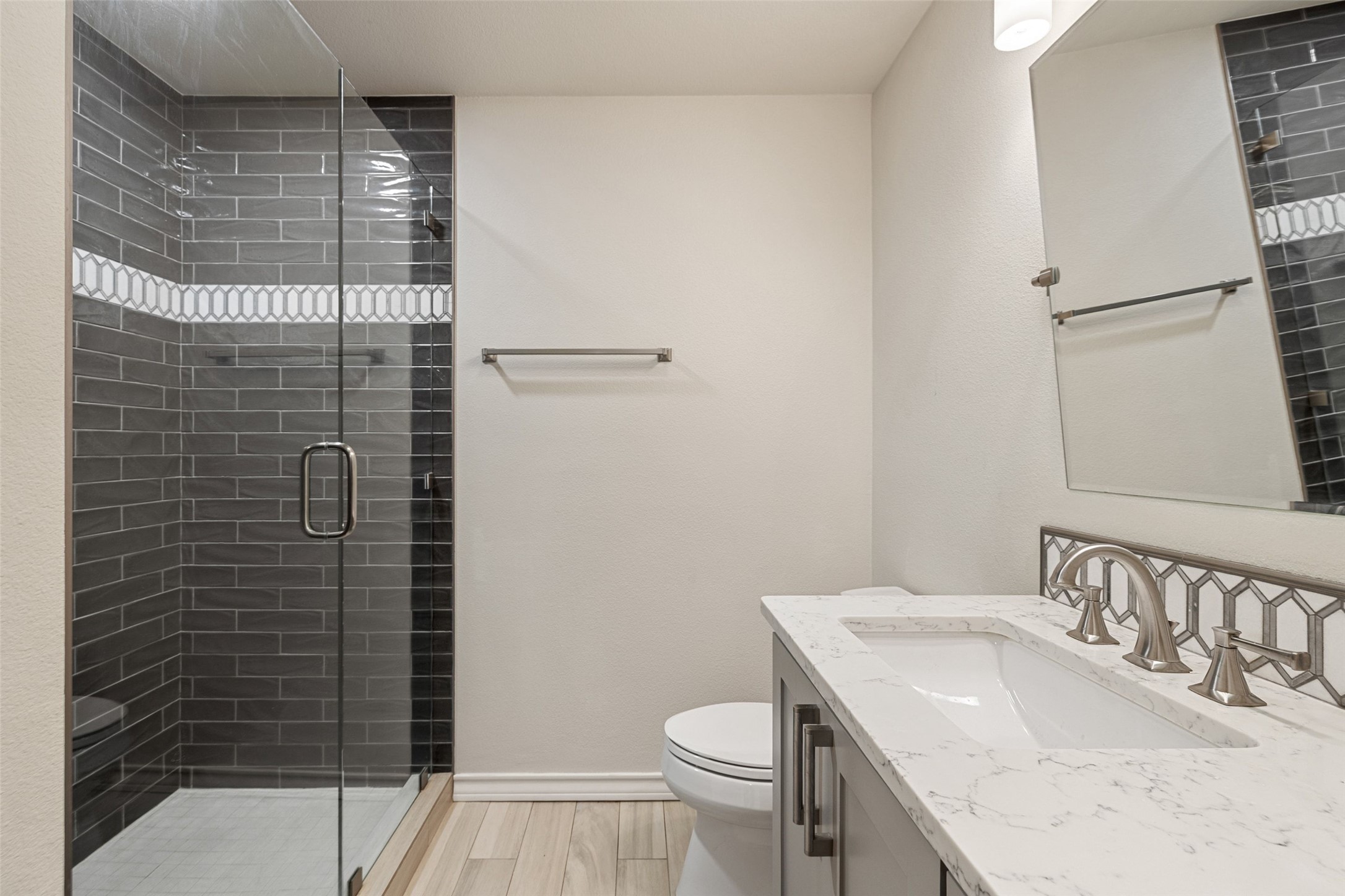 7609 Sandia Loop Austin, TX 78735 - Photo 35 of 40 Glass-enclosed shower with subway tile surround and decorative accent band
