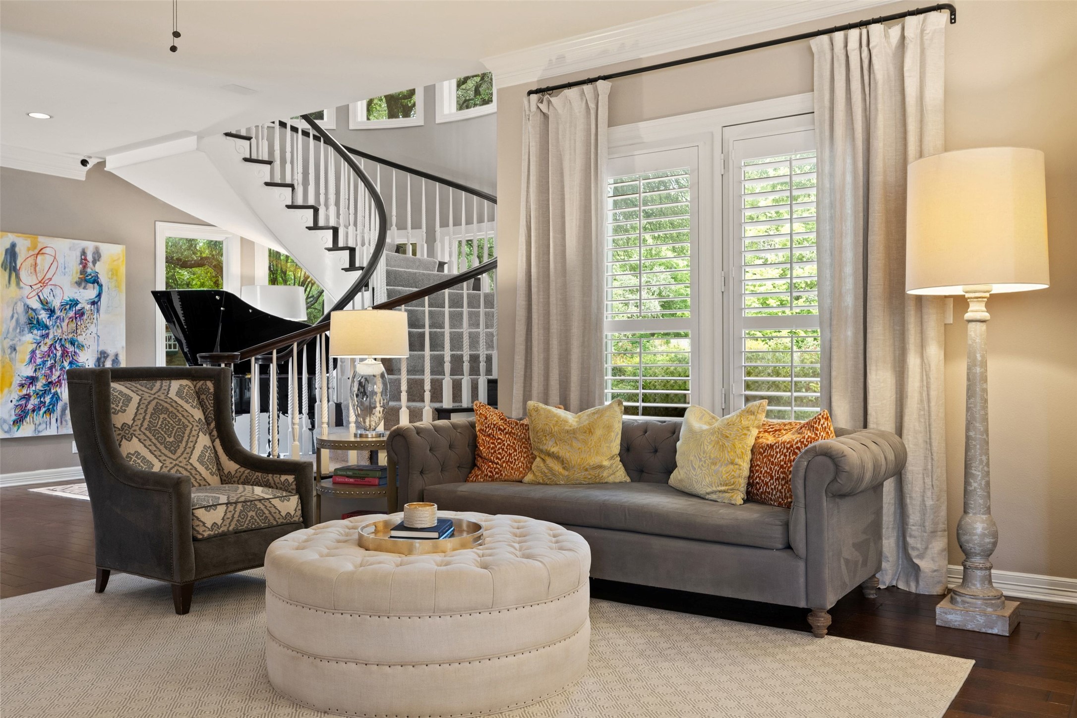 7609 Sandia Loop Austin, TX 78735 - Photo 4 of 40 Living space featuring a curved staircase with dark wood treads and white risers