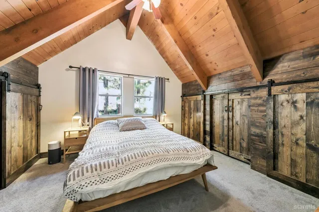 a bedroom with a bed next to a window