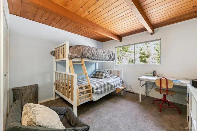 a bedroom with furniture and a window