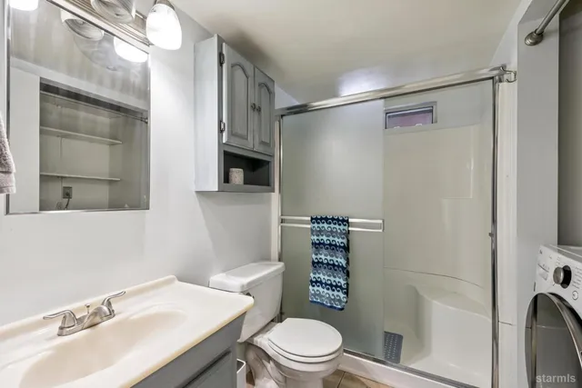 a bathroom with a sink toilet and shower