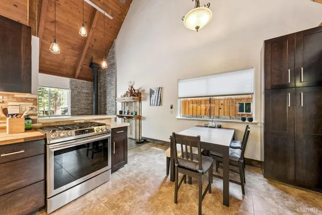 a kitchen with a stove and a dining table