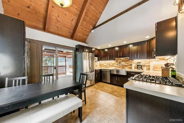 a kitchen with a table chairs stove and refrigerator