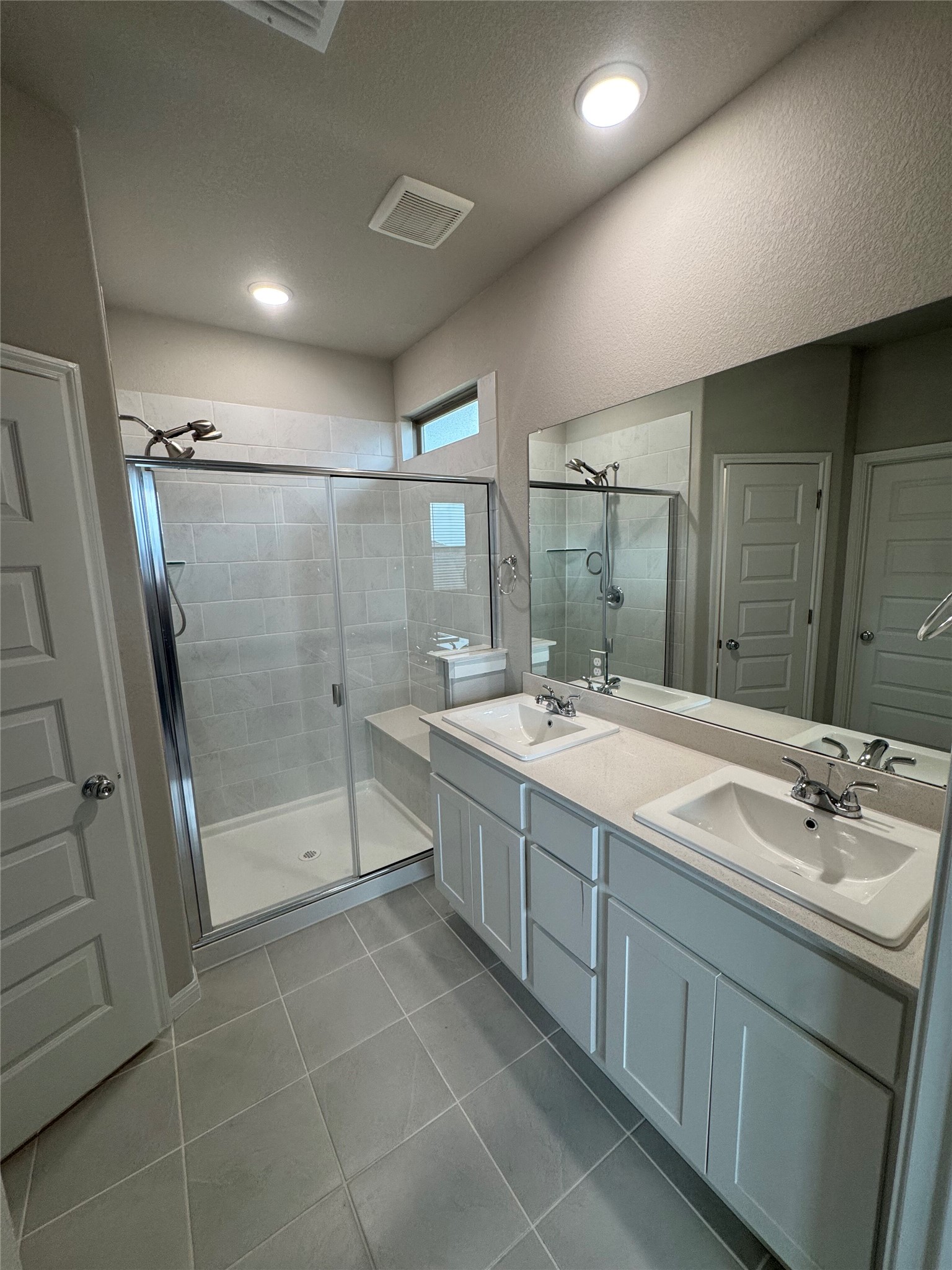 108 Bendecido Loop Elgin, TX 78621 - Photo 8 of 14 a bathroom with a granite countertop sink mirror and shower