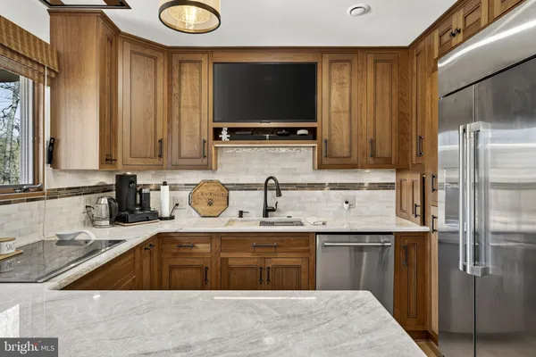 a view of living room kitchen with furniture and fireplace