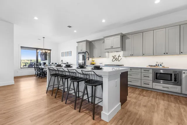 a kitchen with a sink stainless steel appliances and cabinets