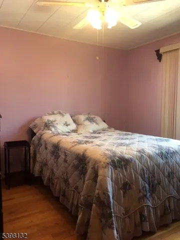 a bed sitting in a bedroom next to a lamp
