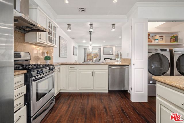 a kitchen with a sink a stove and cabinets
