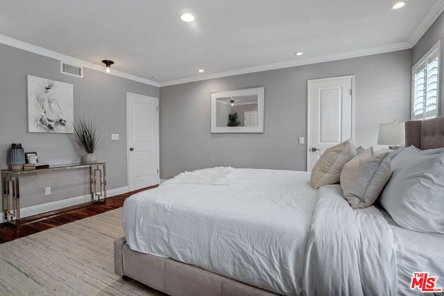 a bedroom with a large bed and a dresser