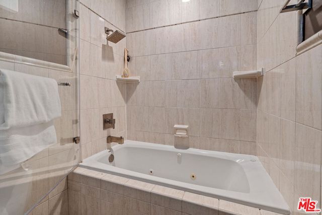 a bathroom with a bathtub and a shower