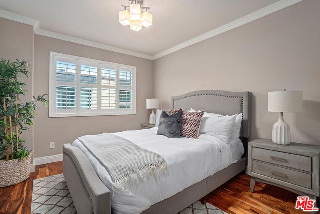 a bedroom with a bed and a lamp with window