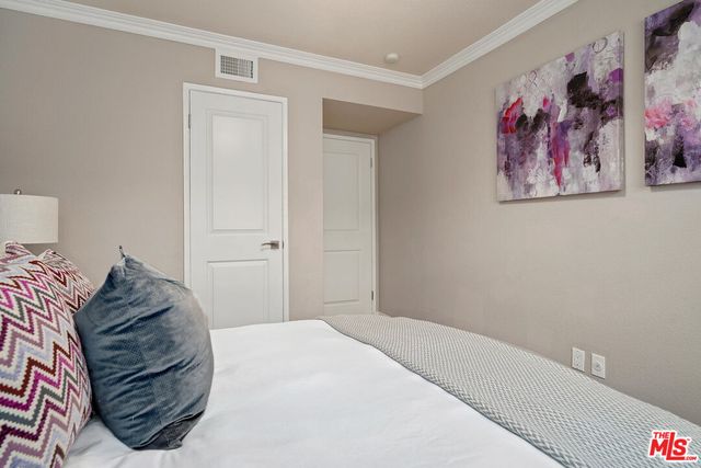 a bedroom with a bed and wall painting