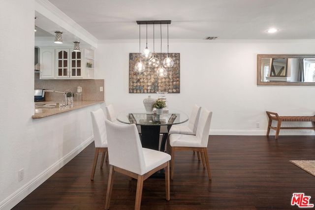 a view of a dining room with furniture wooden floor and chandelier