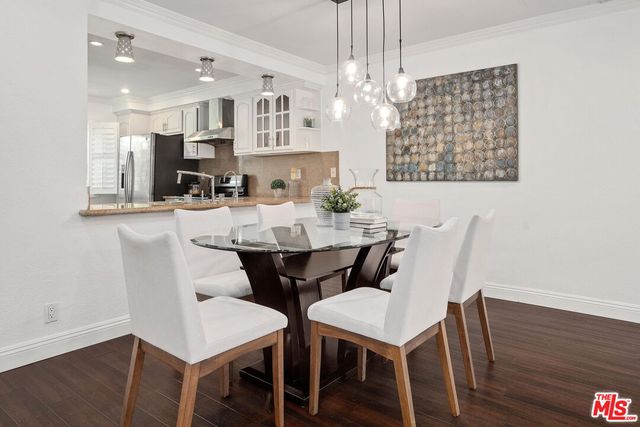 a view of a dining room with furniture wooden floor and chandelier