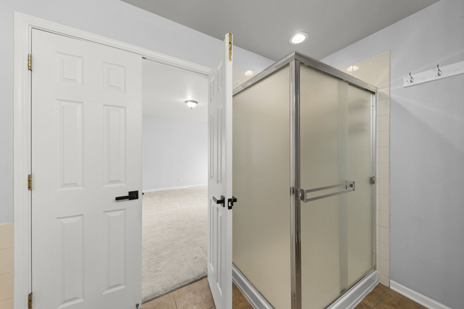 4216 Drexel Avenue Aurora, IL 60504 - Photo 20 of 48 a bathroom with a shower and a glass door