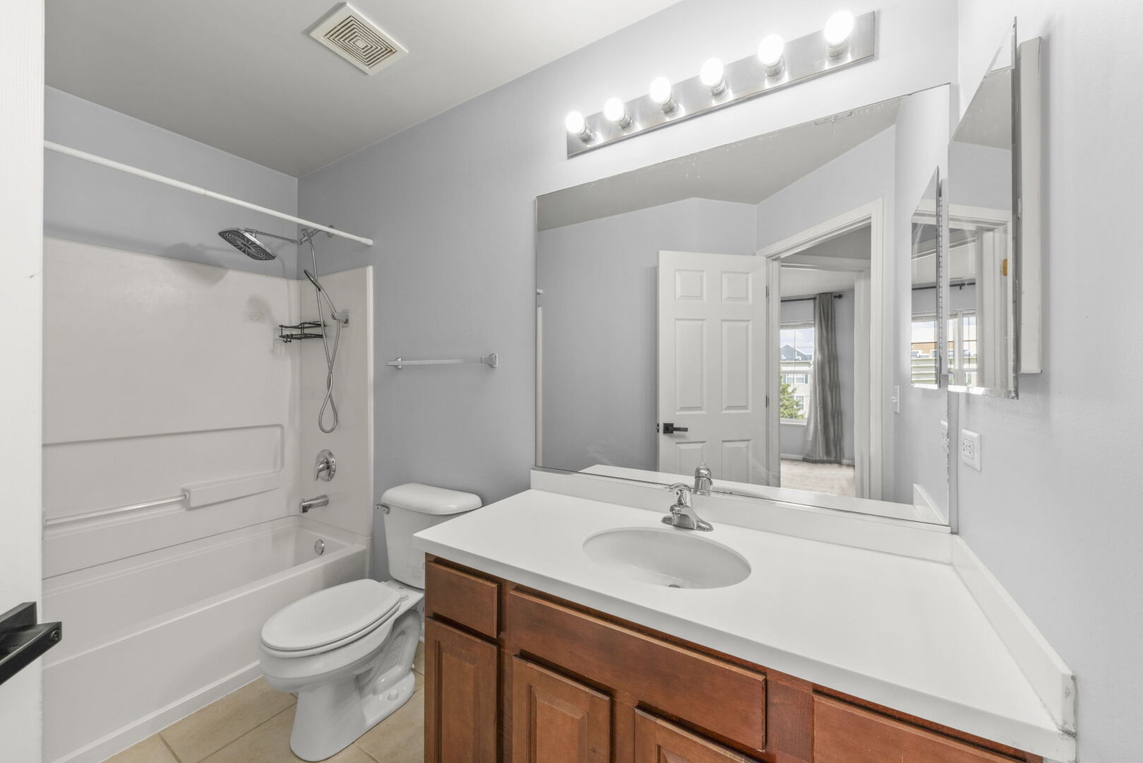 4216 Drexel Avenue Aurora, IL 60504 - Photo 29 of 48 a bathroom with a sink a toilet a mirror and shower