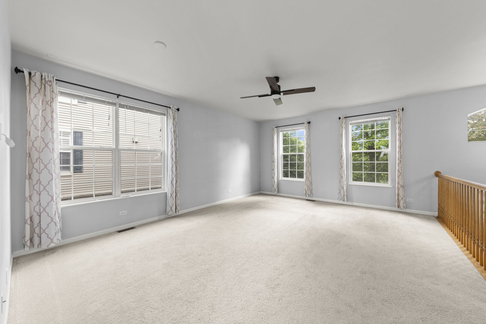 4216 Drexel Avenue Aurora, IL 60504 - Photo 7 of 48 a view of a big room with windows and chandelier fan