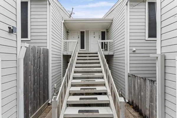 a view of a hallway view with wooden floor and staircase