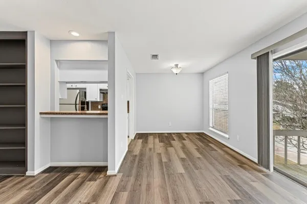 a kitchen with granite countertop a sink stove and cabinets