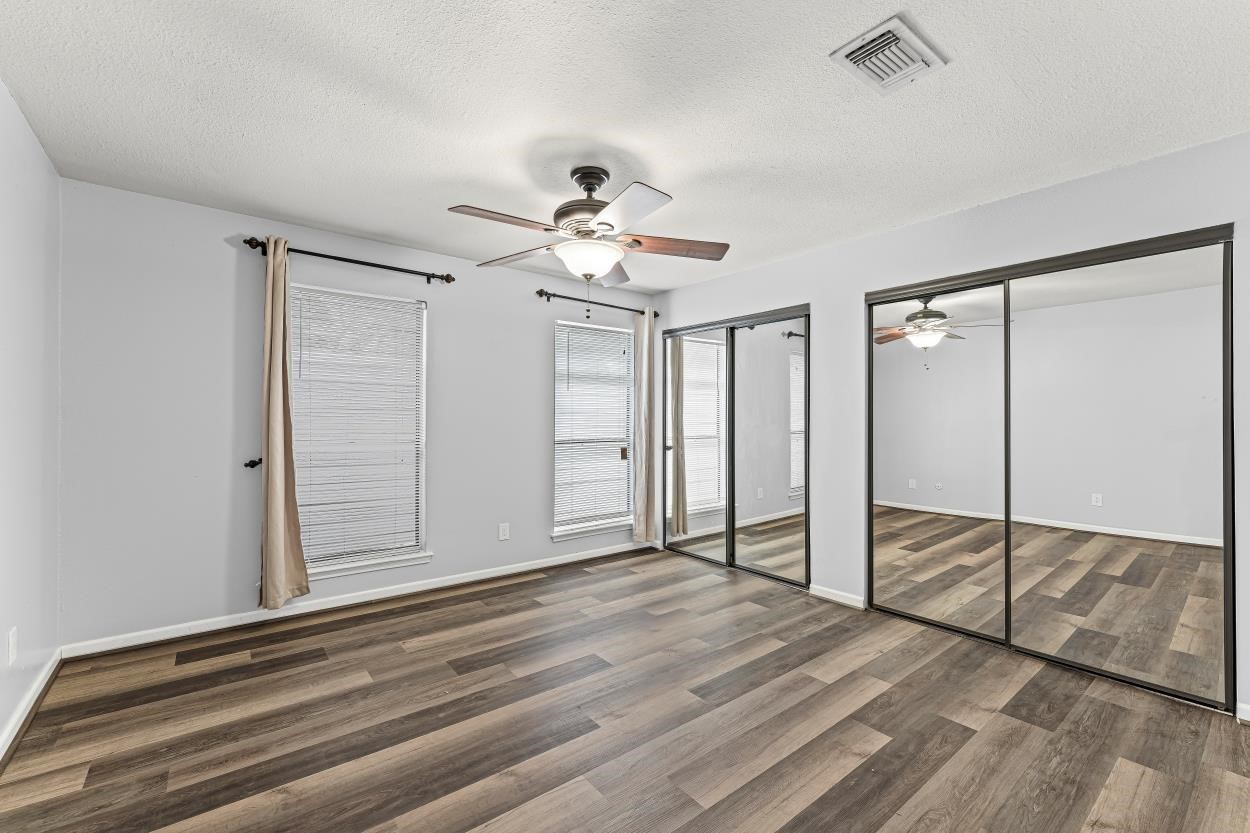 19 Hideaway Drive Friendswood, TX 77546 - Photo 8 of 11 wooden floor in an empty room with a window