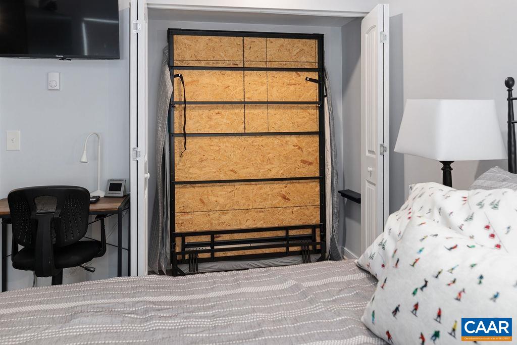 1411 Highlands Condos Roseland, VA 22967 - Photo 35 of 58 a bedroom with a bed and wooden floor