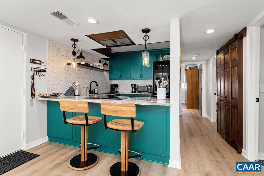 1411 Highlands Condos Roseland, VA 22967 - Photo 4 of 58 a kitchen with stainless steel appliances granite countertop a sink and a refrigerator