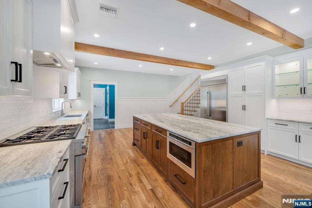 28 North Street Ramsey, NJ 07446 - Photo 15 of 50 a kitchen with stainless steel appliances granite countertop a stove and a sink