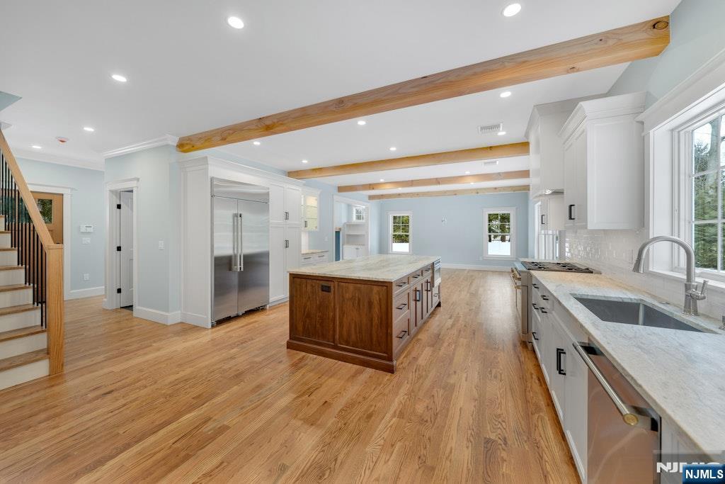 28 North Street Ramsey, NJ 07446 - Photo 19 of 50 a large kitchen with stainless steel appliances granite countertop a lot of counter space and wooden floors