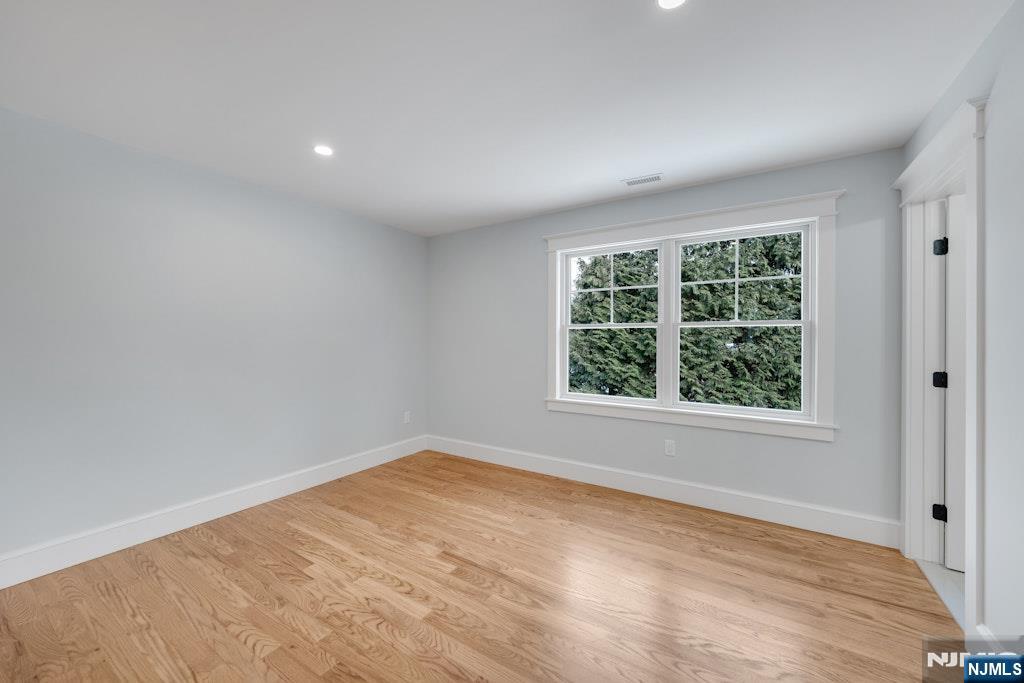 28 North Street Ramsey, NJ 07446 - Photo 32 of 50 an empty room with wooden floor and windows