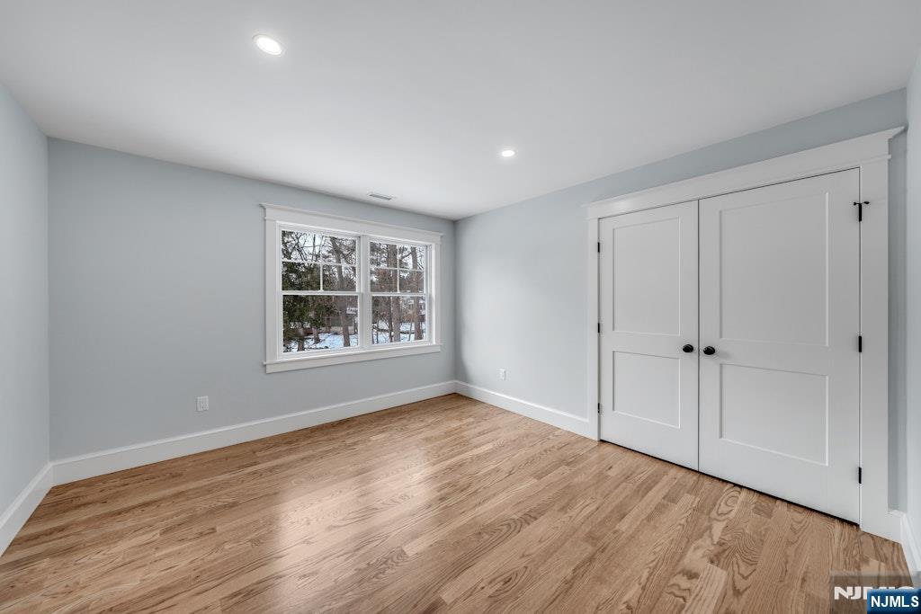 28 North Street Ramsey, NJ 07446 - Photo 34 of 50 a view of an empty room with wooden floor and a window