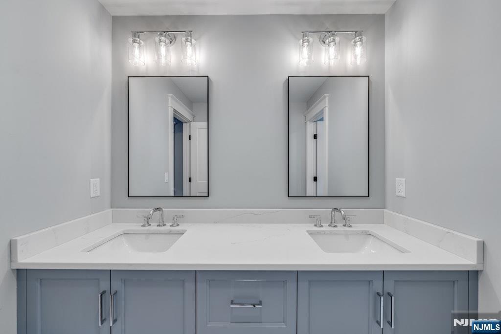 28 North Street Ramsey, NJ 07446 - Photo 36 of 50 a bathroom with double vanity sinks and a mirror