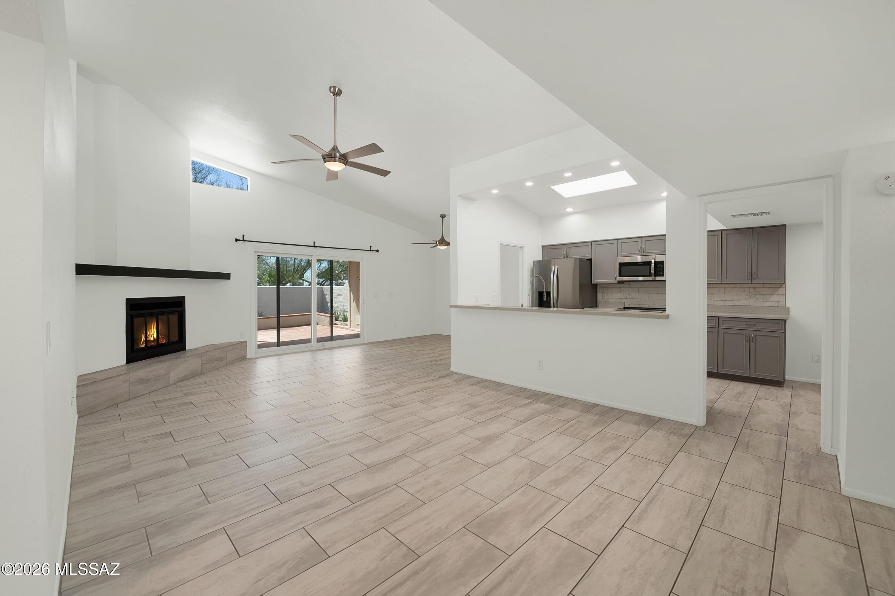 7408 East Wandering Road Tucson, AZ 85750 - Photo 6 of 25 a view of a kitchen with a sink and a fireplace