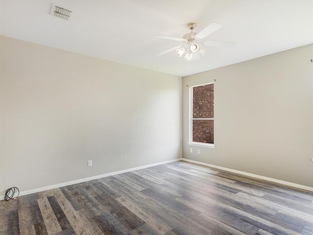 2009 Cooper Ridge Lane Heartland, TX 75126 - Photo 7 of 40 wooden floor in an empty room with a window