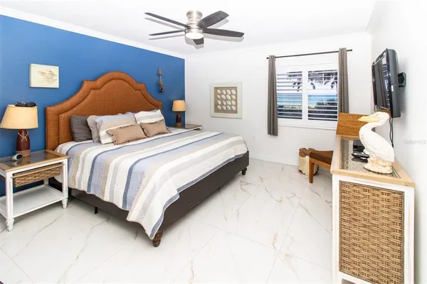 a spacious bedroom with a bed and a window