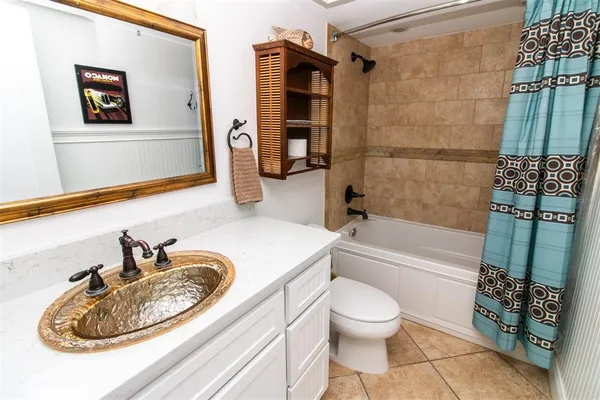 a bedroom with double bed and a chandelier