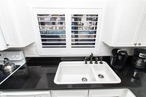 a kitchen with stainless steel appliances kitchen island granite countertop a refrigerator and microwave